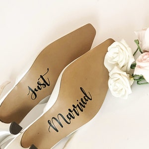 May include: A pair of white bridal shoes with the words "Just Married" written on the soles.