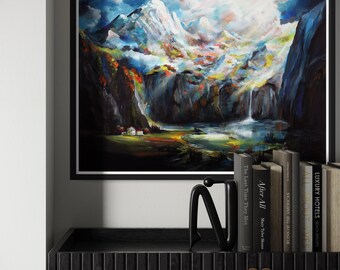 May include: A framed landscape painting showing a mountain range with a waterfall and a village. The artwork uses vibrant colours and a dramatic sky. A black sculpture and books are on a black cabinet.