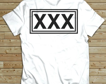May include: White t-shirt with a black rectangle containing the text "XXX" printed on the back.