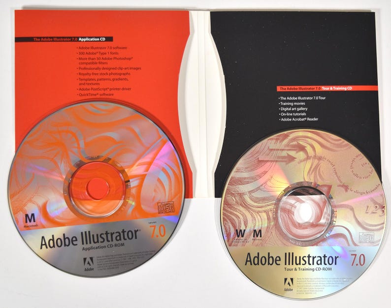 May include: Two CD-ROMs for Adobe Illustrator 7.0. The application CD-ROM is red and orange with the text "Adobe Illustrator 7.0 Application CD-ROM". The tour and training CD-ROM is gold and red with the text "Adobe Illustrator 7.0 Tour & Training CD-ROM".