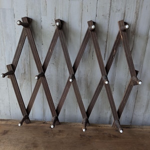 May include: A rustic wooden sign with the text "Welcome to our home" in white lettering. The sign features a distressed finish and a simple, inviting design, perfect for entryway decor.