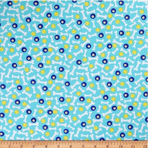 May include: A blue fabric with a repeating pattern of white bones, yellow tennis balls, and blue stars.