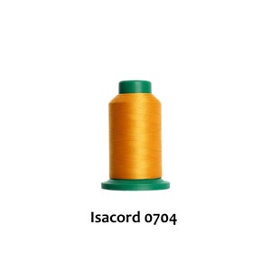 May include: A spool of bright yellow thread with a green plastic top and bottom. The label reads "Isacord 0704".