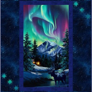 May include: A rectangular fabric quilt panel featuring a nighttime winter landscape with a moose standing near a river, a cabin with glowing windows, snow-covered mountains, and vibrant green and purple aurora borealis in a starry sky.