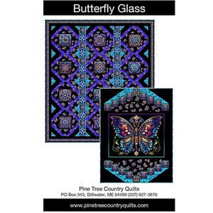 May include: A quilt pattern featuring a large, colorful butterfly design with intricate details. The butterfly is set against a black background, with a smaller version of the design below. The text "Butterfly Glass" is at the top.