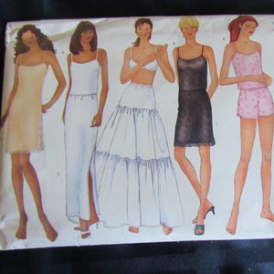 May include: A Butterick 6777 sewing pattern envelope featuring illustrations of five different undergarment styles including a short slip, a long slip, a full petticoat, a camisole top, and a matching short set with a floral print pattern.