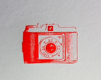 Letterpress poster vintage camera in neon red.