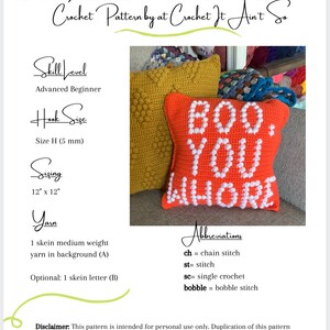 May include: A crochet pillow with the text "BOO. YOU WHORE" in white yarn on a red background. The pillow is 12 inches by 12 inches and is made with a size H (5 mm) crochet hook. The pattern is for personal use only.