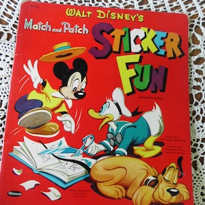 May include: A vintage Walt Disney's Match and Patch Sticker Fun book with a red cover. Mickey Mouse, Donald Duck, and Pluto are featured on the cover. The book is an authorised edition and includes a Whitman Publishing Co. copyright.