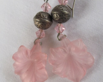 May include: A pair of dangle earrings with pink flower-shaped charms, silver beads, and pink crystal accents.
