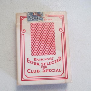 May include: A white box of playing cards with a red diamond pattern on the back. The box says "Back No 67 Extra Selected for Club Special".
