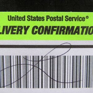 May include: A green and white label with the text "United States Postal Service® DELIVERY CONFIRMATION™" and a black barcode with a handwritten signature.