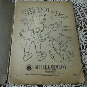 May include: A vintage "Draw From Dot to Dot" coloring book with a black and white illustration of a girl and a dog holding crayons. The book cover has the title "Draw From Dot to Dot" and "Color Book" printed in black text. The book is published by Merrill Company, Chicago, Illinois.
