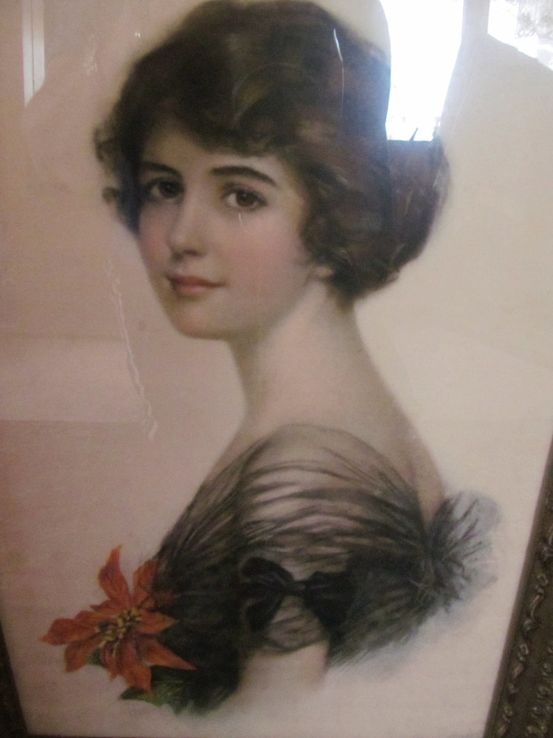 May include: A vintage portrait of a woman with dark hair wearing a black lace dress and a red poinsettia flower.