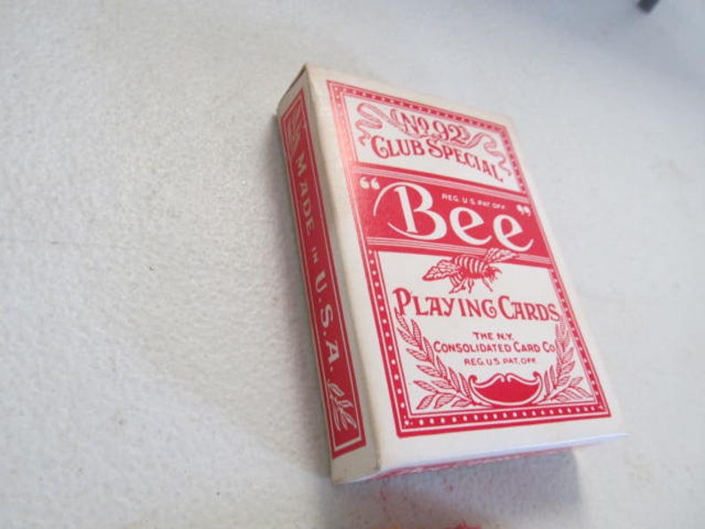 May include: A red and white box of Bee playing cards. The box has the text "No. 92 Club Special" and "Bee Playing Cards" printed on it. The box is made in the USA.