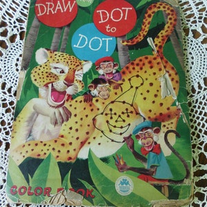 May include: A vintage "Draw from Dot to Dot" coloring book featuring a leopard with three monkeys. The cover is green with a red and blue dot design. The book is titled "Draw from Dot to Dot" and "Color Book".