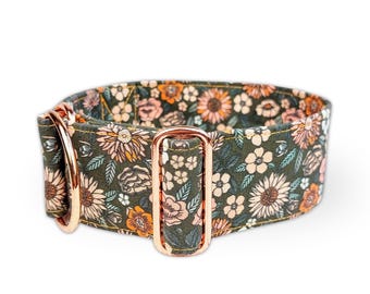 May include: A pet collar featuring a dark olive green fabric base with a repeating floral pattern in shades of orange, peach, and cream. The collar includes rose gold metal hardware, specifically a D-ring and an adjustable slider buckle.