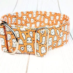 May include: Orange and white dog collar with a pattern of cute ghosts and stars. The collar has silver metal hardware.