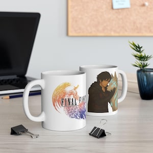May include: Two white ceramic mugs. One mug features the "FINAL FANTASY" logo in orange, yellow, purple, and blue. The other mug has an illustration of a person with a wolf. The mugs are on a light-colored surface.