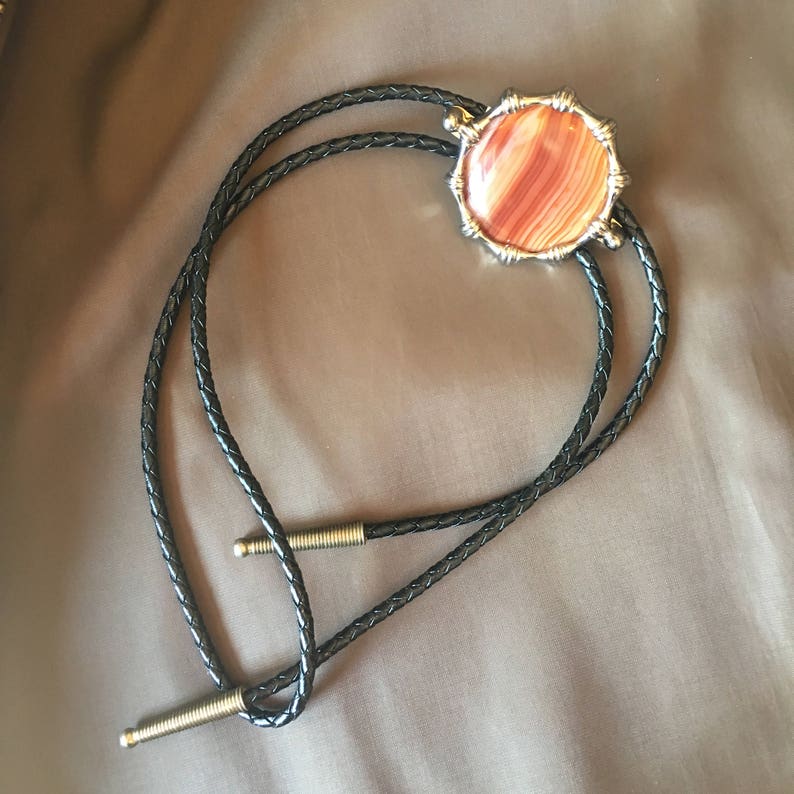 Western Orange Round Agate with Gold Metal Frame Black Cord and Brass Metal Tips