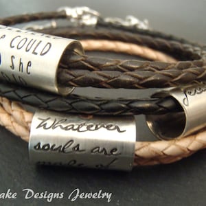 May include: A set of three braided leather bracelets in dark brown and tan, each featuring a cylindrical silver-toned metal bead. The beads are engraved with the phrases "SHE COULD SO SHE DID," "Whatever souls are made of," and a name with a heart.