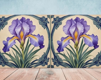 May include: Two ceramic tiles with a decorative design featuring a purple iris flower with yellow accents. The tiles have a blue and white border with a floral motif.
