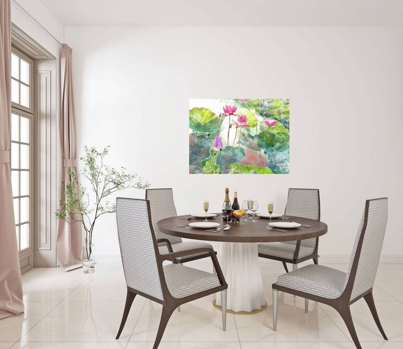May include: A dining room featuring a round wooden table set for a meal. Four chairs with patterned backs surround the table. A painting of pink lotus flowers and green leaves hangs on the wall. A window with pink curtains is on the left.