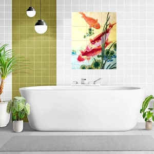 May include: A white bathtub with a chrome faucet and a decorative tile featuring a watercolor painting of red and orange fish swimming in a pond with green reeds.