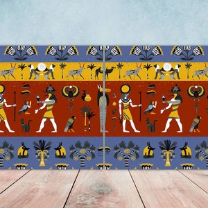 May include: A pair of colourful wall art prints featuring an Egyptian-inspired design with repeating patterns of gods, animals, and symbols. The prints are framed in a simple black frame.