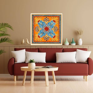 May include: A square wall art print with a colorful geometric design. The design features a central orange square with blue and red floral patterns. The background is a light yellow color.