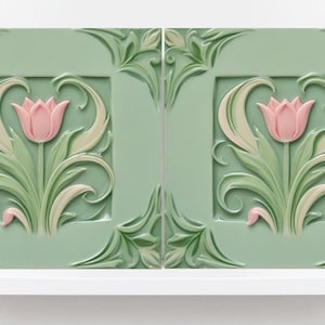 May include: Two green ceramic tiles featuring a raised design of pink tulips and white leaves. The tiles are framed with a decorative border.