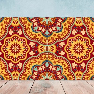 May include: A decorative tile with a red, yellow, and blue geometric pattern. The tile has a repeating design of floral motifs and intricate details.