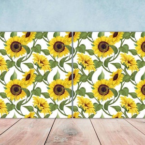 May include: Two canvases with a white background and a repeating pattern of yellow sunflowers with green leaves.