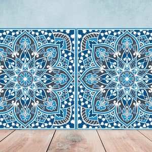 May include: Two square blue and white patterned tiles with intricate floral designs. The tiles have a white background with blue and gray floral patterns.