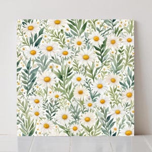 May include: A square canvas print with a watercolour floral pattern. The design features a dense arrangement of white daisies with yellow centres, interspersed with green leaves and foliage against a white background.