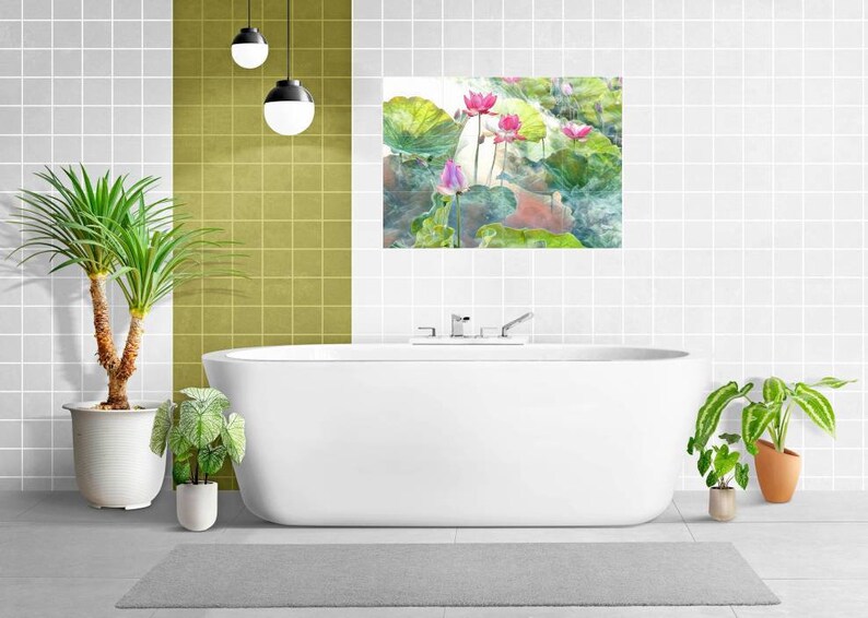 May include: A contemporary bathroom featuring a white bathtub, a grey rug, and potted plants. A watercolour painting of pink lotus flowers and green leaves hangs above the tub. The walls are white with a grid pattern, and there are hanging globe lights.