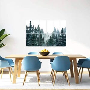 May include: A dining room with a light wood table and four blue chairs. A framed print of a watercolor forest scene hangs on the wall above the table.