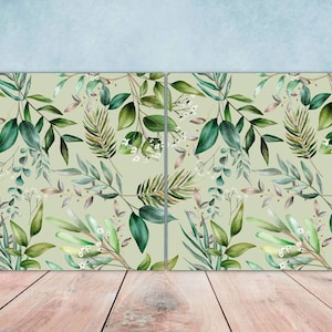 May include: A seamless pattern featuring watercolour illustrations of green leaves and white flowers on a light green background.