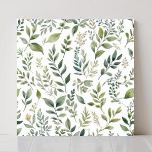 May include: Square canvas art with a watercolour botanical design. The artwork displays a repeating pattern of green leaves and branches in various shades, set against a white background. The leaves vary in size and shape, creating a natural, organic feel.