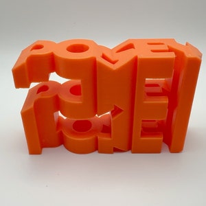 May include: Orange 3D printed word "ROXY" with each letter stacked on top of each other.