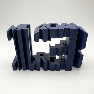 May include: A 3D printed sculpture of the word "MORGAN" in navy blue. The letters are stacked on top of each other, creating a unique and modern design.