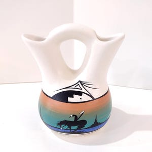 May include: A set of three ceramic mugs with a speckled, matte finish. The mugs are in shades of cream, light gray, and dark gray. Each mug has a simple, minimalist design and a rounded handle.