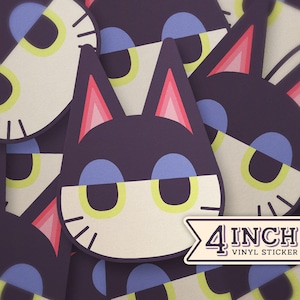 May include: A 4 inch vinyl sticker featuring a cartoon cat with purple fur, pink ears, yellow eyes, and a white face. The cat is wearing a blue and white mask.