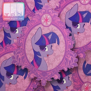 May include: A set of purple and pink stickers featuring a cartoon purple unicorn with a pink mane and tail. The unicorn is wearing a crown and has a pink star on its forehead. The stickers are surrounded by a decorative purple frame.