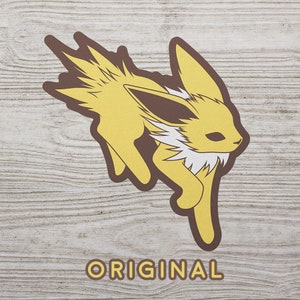 May include: A yellow and brown cartoon illustration of a fox-like Pokemon character with a white fluffy tail and a brown ear. The character is running and the word "ORIGINAL" is printed below the character.