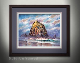 May include: A watercolor painting of a large rock formation, Haystack Rock, on the Oregon coast. The rock is brown and tan with a blue and purple sky above. The ocean is a light blue with white waves crashing against the shore.