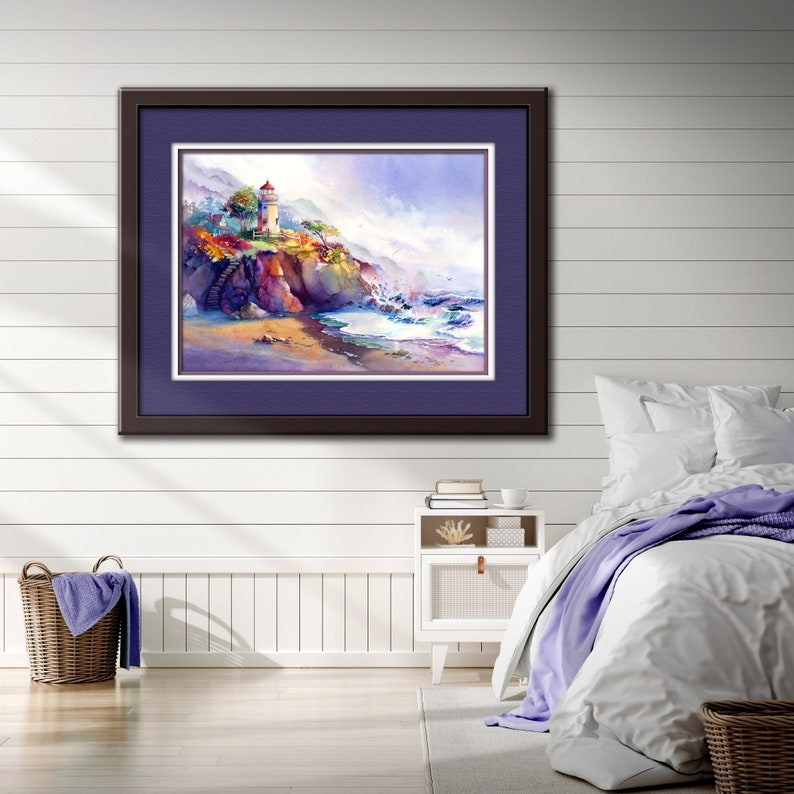 May include: A framed watercolor painting of a lighthouse on a cliff overlooking a rocky beach with crashing waves. The sky is a soft blue with white clouds. The lighthouse is white with a red roof.