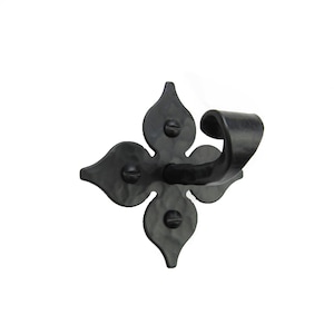 May include: Black metal wall hook with a decorative four-leaf clover design. The hook is curved and has a hammered finish.