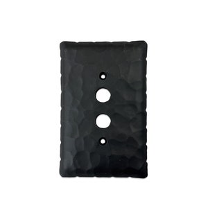 May include: Black hammered metal light switch cover plate with three holes for switches or outlets.