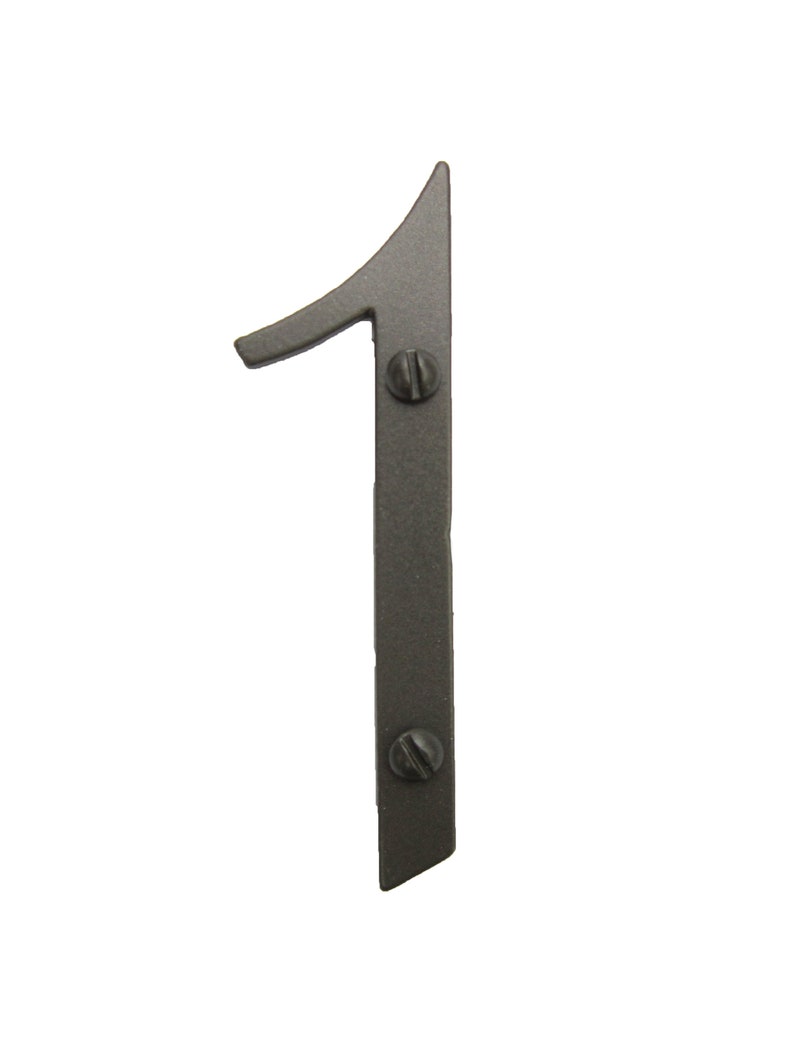 May include: A black metal house number one with a decorative, stylized font. The number is attached to a surface with two screws.